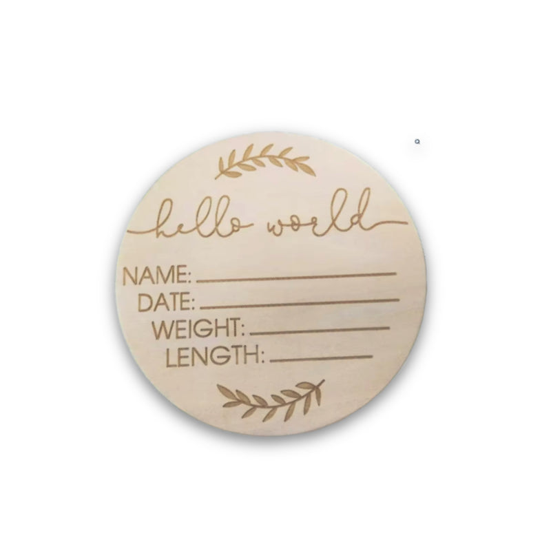 Round wooden card with 'hello world' and fields for name, date, weight, and length on a white background